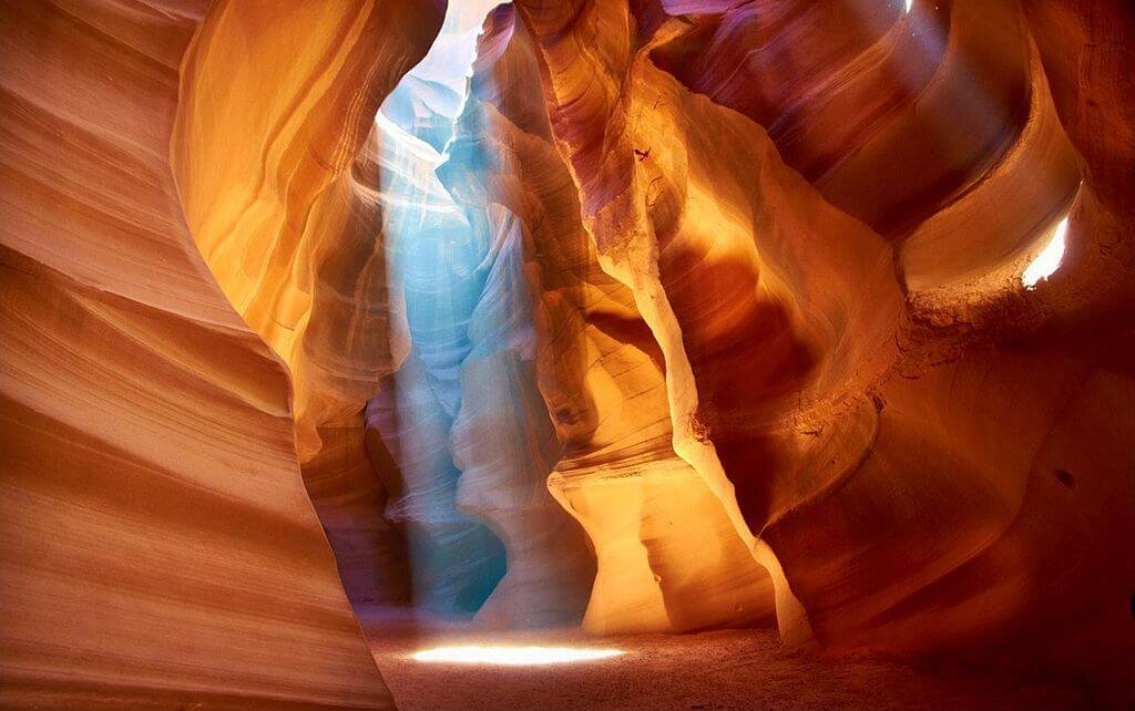 Vista interior de Antelope Canyon durante o dia, com paredes esculpidas particulares visíveis ao fundo.